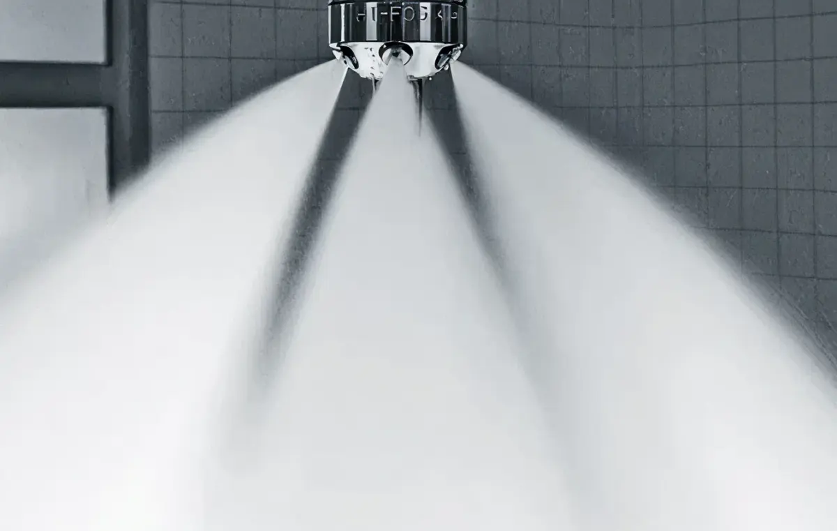 Water mist fire suppression nozzles in a marine space