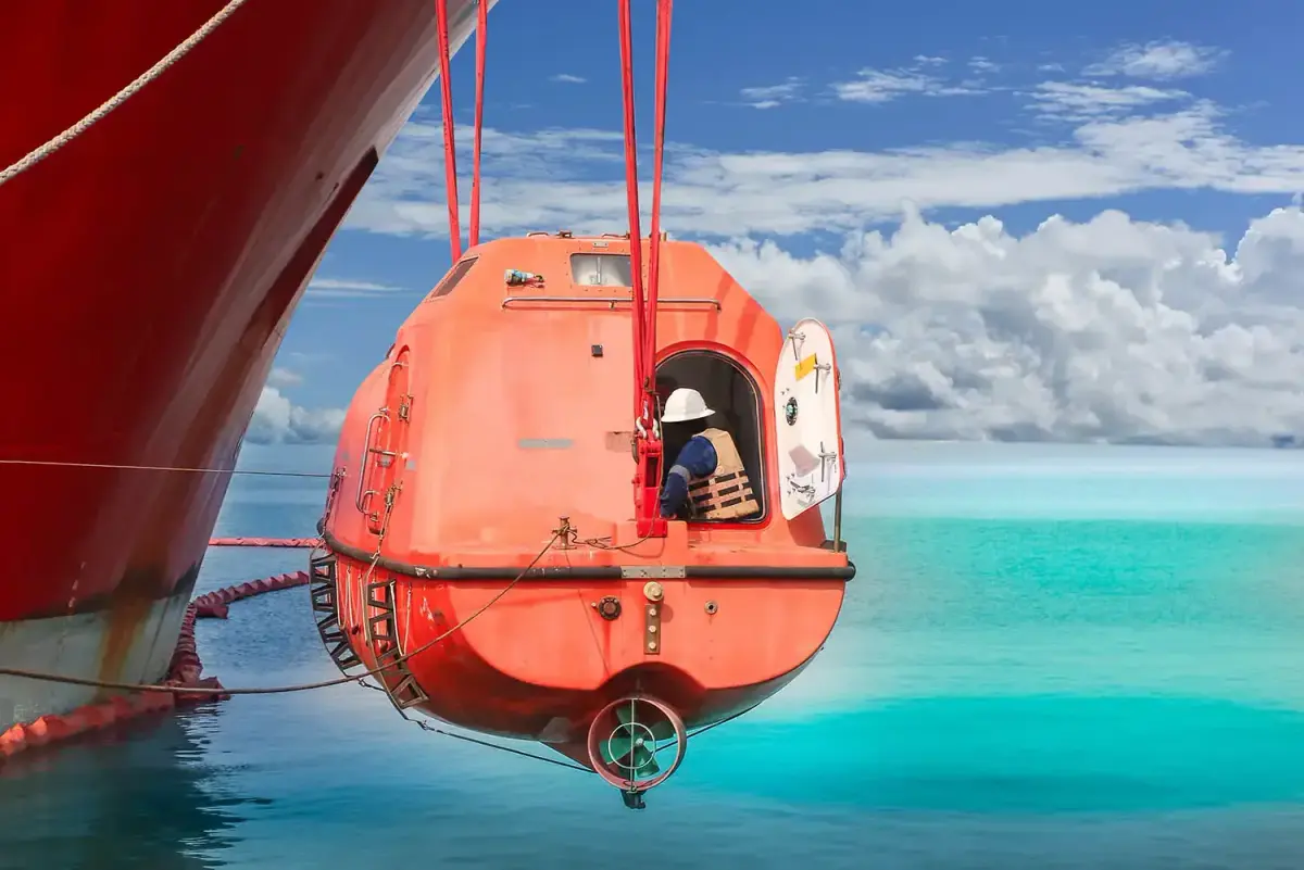 Lifeboat suspended from davits above the sea