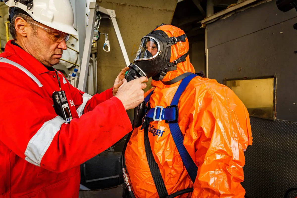 Crew member checking a protective immersion suit