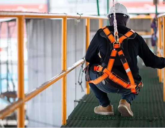 Worker wearing a full-body fall protection harness