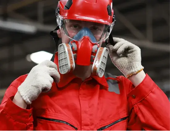 Worker wearing a full-face respiratory mask